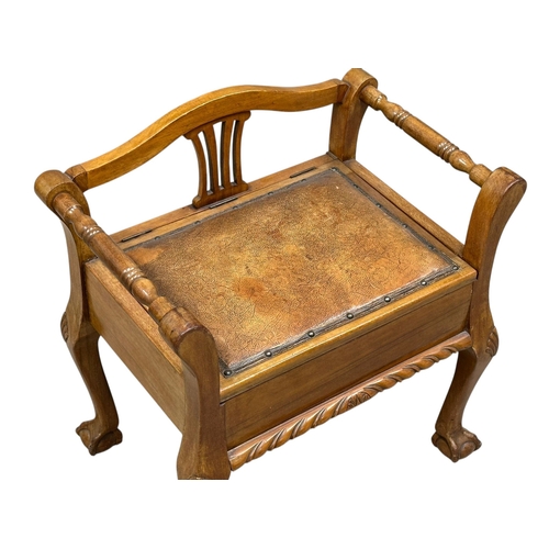 50 - A Chippendale style walnut piano stool. 1930-1950. (2)