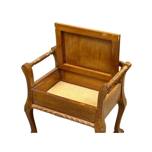 50 - A Chippendale style walnut piano stool. 1930-1950. (2)