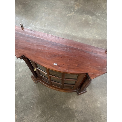 225 - A mahogany wall hanging cabinet. 75x25.5x71cm.