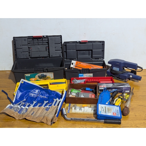 231 - Quantity of tools including 2 tool boxes, electric sander, Everest spanners set, drill bits etc