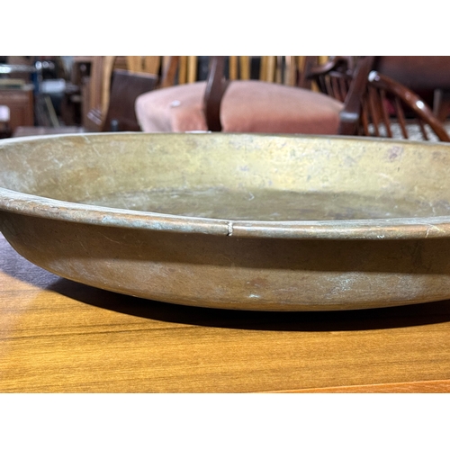 240 - A large early 20th century brass ceremonial bowl. 48.5x7.5cm.
