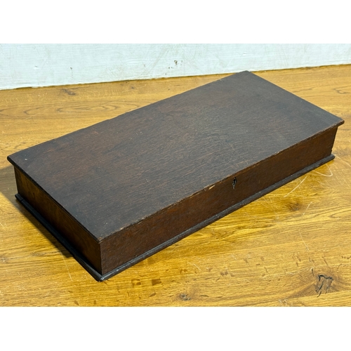 242 - Silver plated cutlery in and early 20th century oak box. 54.5x24.5x8.5cm.