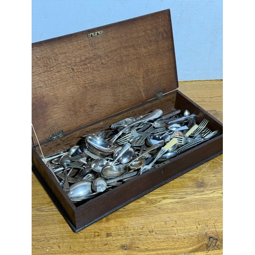 242 - Silver plated cutlery in and early 20th century oak box. 54.5x24.5x8.5cm.