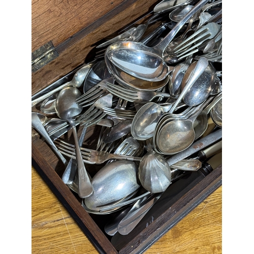 242 - Silver plated cutlery in and early 20th century oak box. 54.5x24.5x8.5cm.