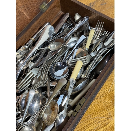 242 - Silver plated cutlery in and early 20th century oak box. 54.5x24.5x8.5cm.