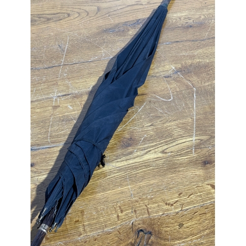 35 - A late Victorian/Edwardian umbrella with 18ct gold plated and mother of pearl handle.