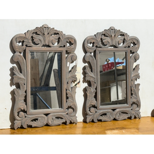 248 - A pair of ornate wooden framed mirrors. 40x60cm.
