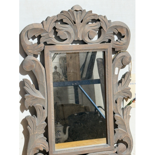248 - A pair of ornate wooden framed mirrors. 40x60cm.