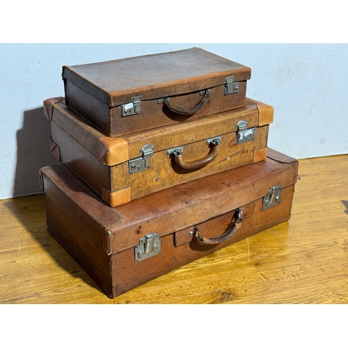 259 - Three vintage leather travelling cases. Largest 67x40x21cm.