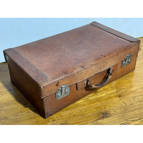 259 - Three vintage leather travelling cases. Largest 67x40x21cm.