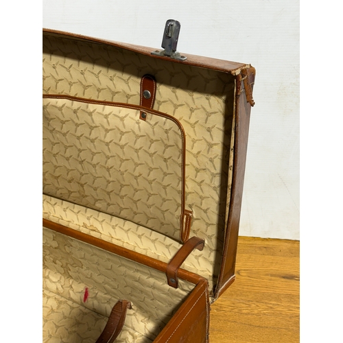 259 - Three vintage leather travelling cases. Largest 67x40x21cm.