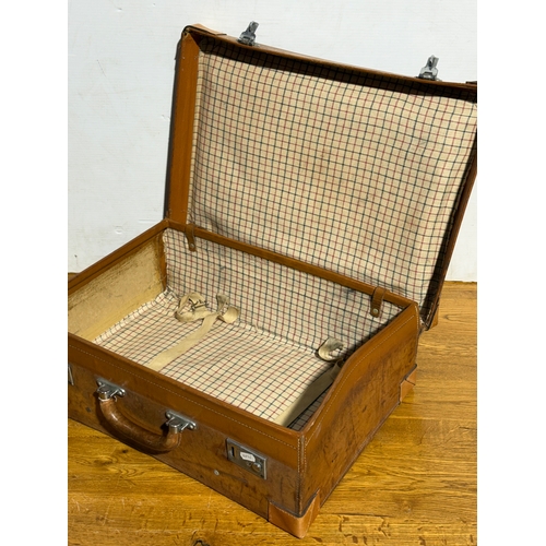 259 - Three vintage leather travelling cases. Largest 67x40x21cm.