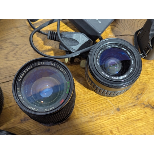 145 - Quantity of cameras and lenses including Nikon, Canon, Vivitar, Cobra etc