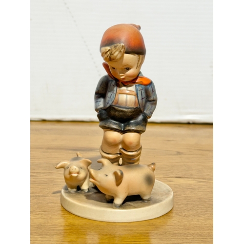 118 - A Goebel Hummel Farm Boy figurine. 8.3x13cm.