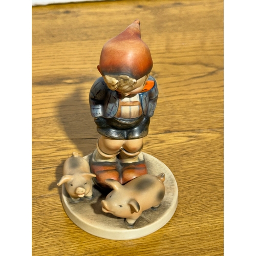 118 - A Goebel Hummel Farm Boy figurine. 8.3x13cm.