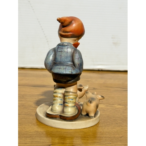 118 - A Goebel Hummel Farm Boy figurine. 8.3x13cm.