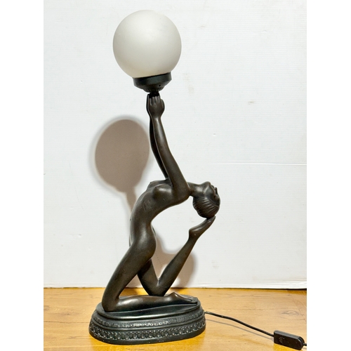68 - A large Art Deco style figural table lamp with frosted glass shade. 74cm.