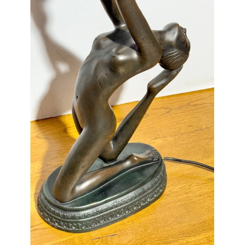 68 - A large Art Deco style figural table lamp with frosted glass shade. 74cm.