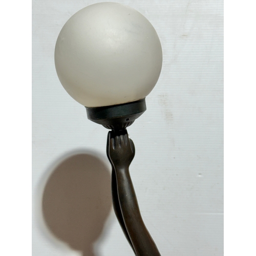 68 - A large Art Deco style figural table lamp with frosted glass shade. 74cm.