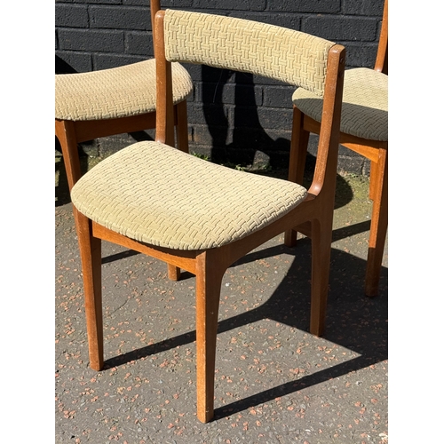 274 - A set of three Nathan teak tuck away dining chairs.