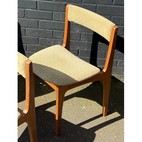 274 - A set of three Nathan teak tuck away dining chairs.