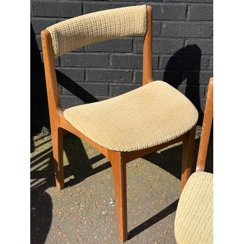 274 - A set of three Nathan teak tuck away dining chairs.
