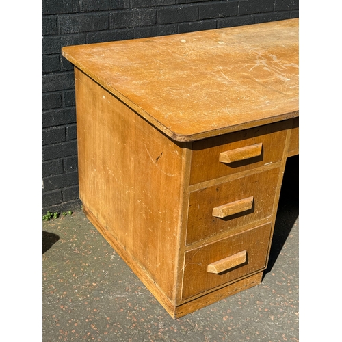 278 - A vintage oak desk. 152.5x91x77cm.