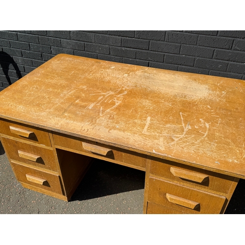 278 - A vintage oak desk. 152.5x91x77cm.