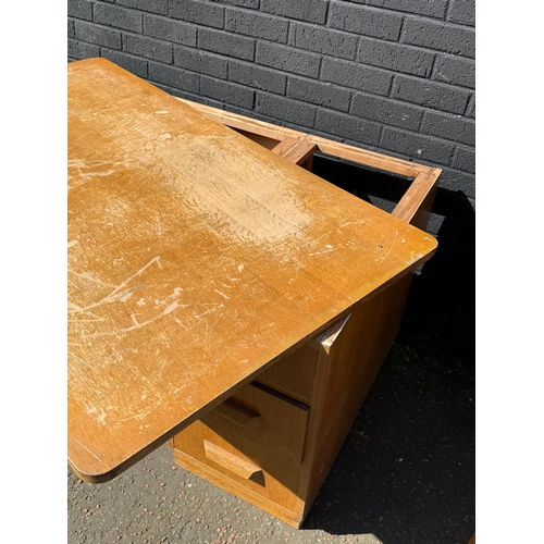 278 - A vintage oak desk. 152.5x91x77cm.