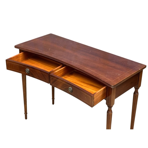 74 - A Georgian style inlaid mahogany concave side table. 99x43x74cm.