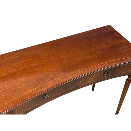 74 - A Georgian style inlaid mahogany concave side table. 99x43x74cm.