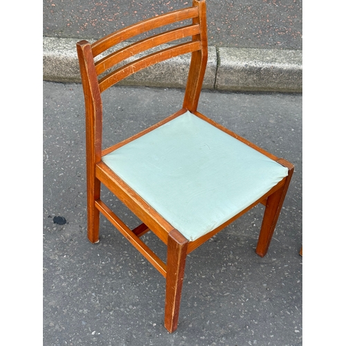 393 - A pair of teak dining chairs.