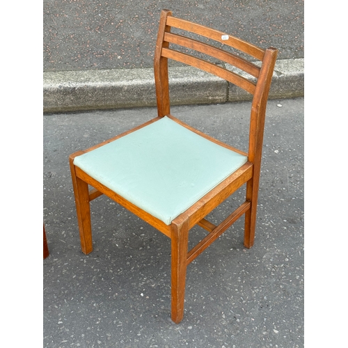 393 - A pair of teak dining chairs.