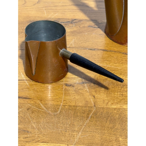 395 - A vintage two piece copper coffee service by Argv.