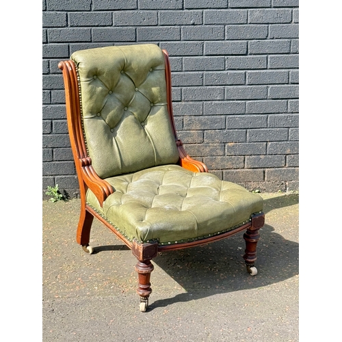 64 - A Victorian mahogany deep buttoned roll back chair