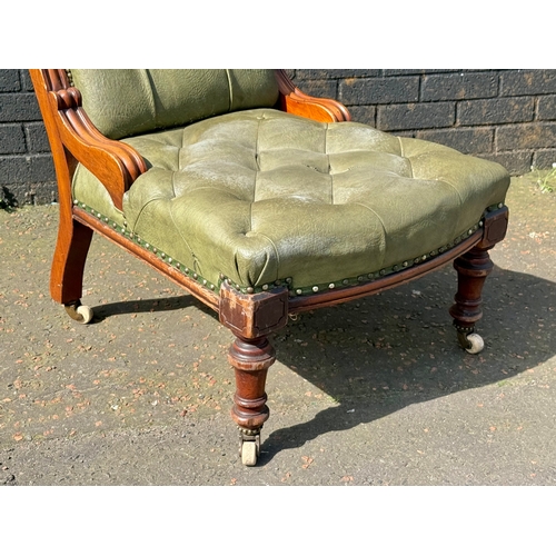 64 - A Victorian mahogany deep buttoned roll back chair