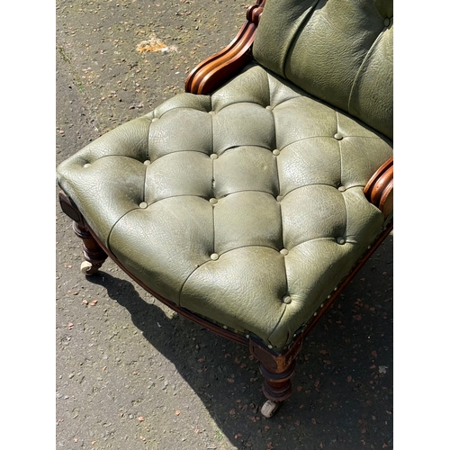 64 - A Victorian mahogany deep buttoned roll back chair