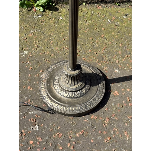 397 - An uplighter with glass shade.