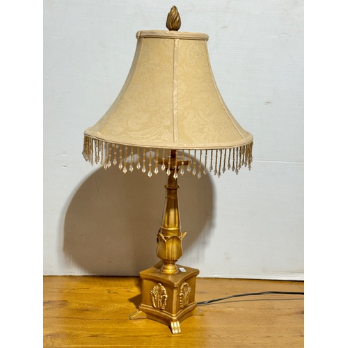 399 - A gilt table lamp. 73cm