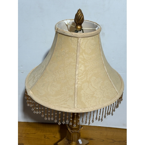399 - A gilt table lamp. 73cm