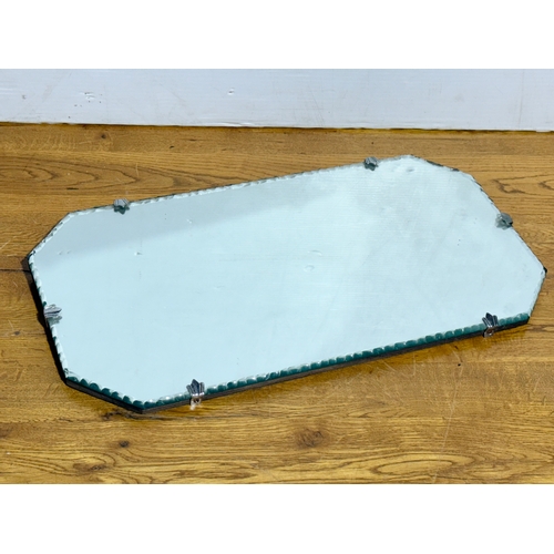 359 - An Art Deco bevelled mirror. 50x27cm