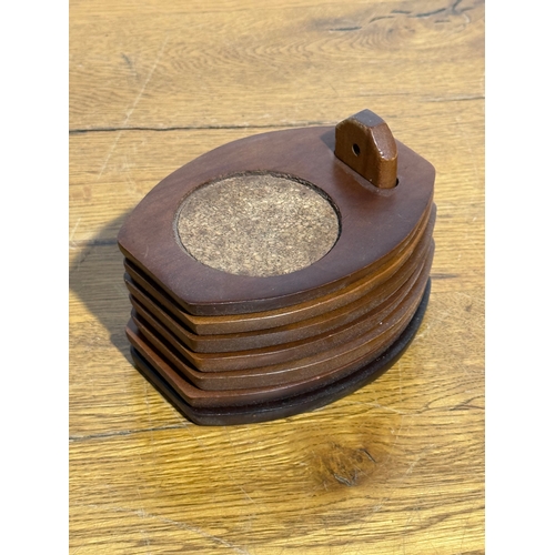 254 - A set of six teak coasters. 9x12.5cm.