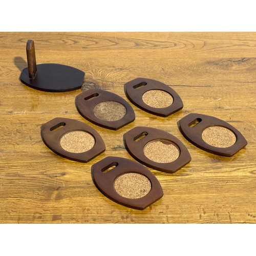 254 - A set of six teak coasters. 9x12.5cm.