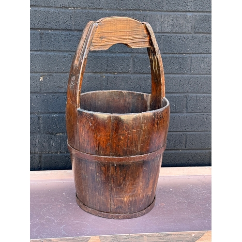 87 - An early 20th century Chinese rice carrier. 61cm