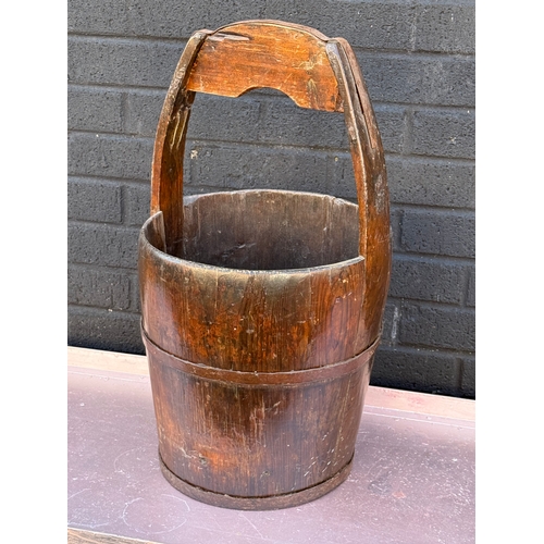 87 - An early 20th century Chinese rice carrier. 61cm