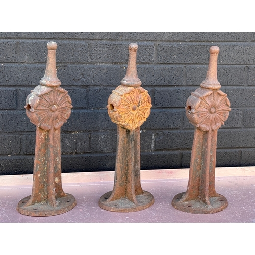 88 - Three early 20th century cast iron fence bollards. 50cm.