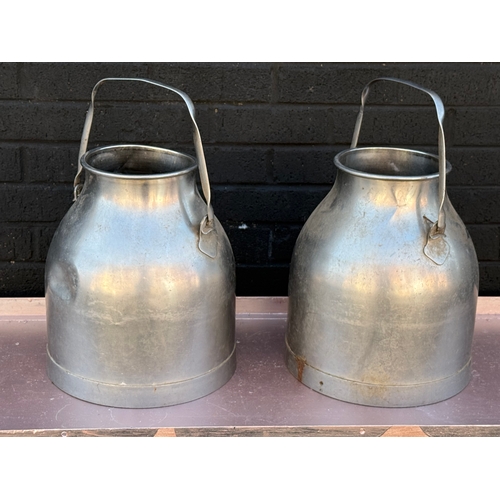 363 - A pair of vintage stainless steel milk churns.