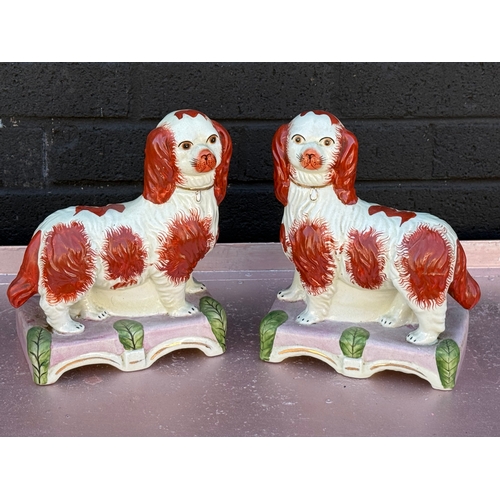 103 - A pair of vintage Victorian style Staffordshire Majesty and Grace figures.