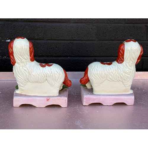 103 - A pair of vintage Victorian style Staffordshire Majesty and Grace figures.