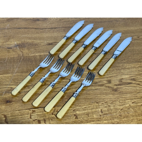 413 - A silver mounted cutlery set.